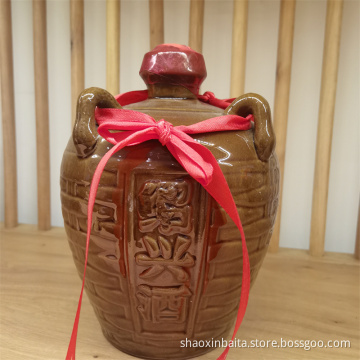 Yellow porcelain jar filled with yellow wine